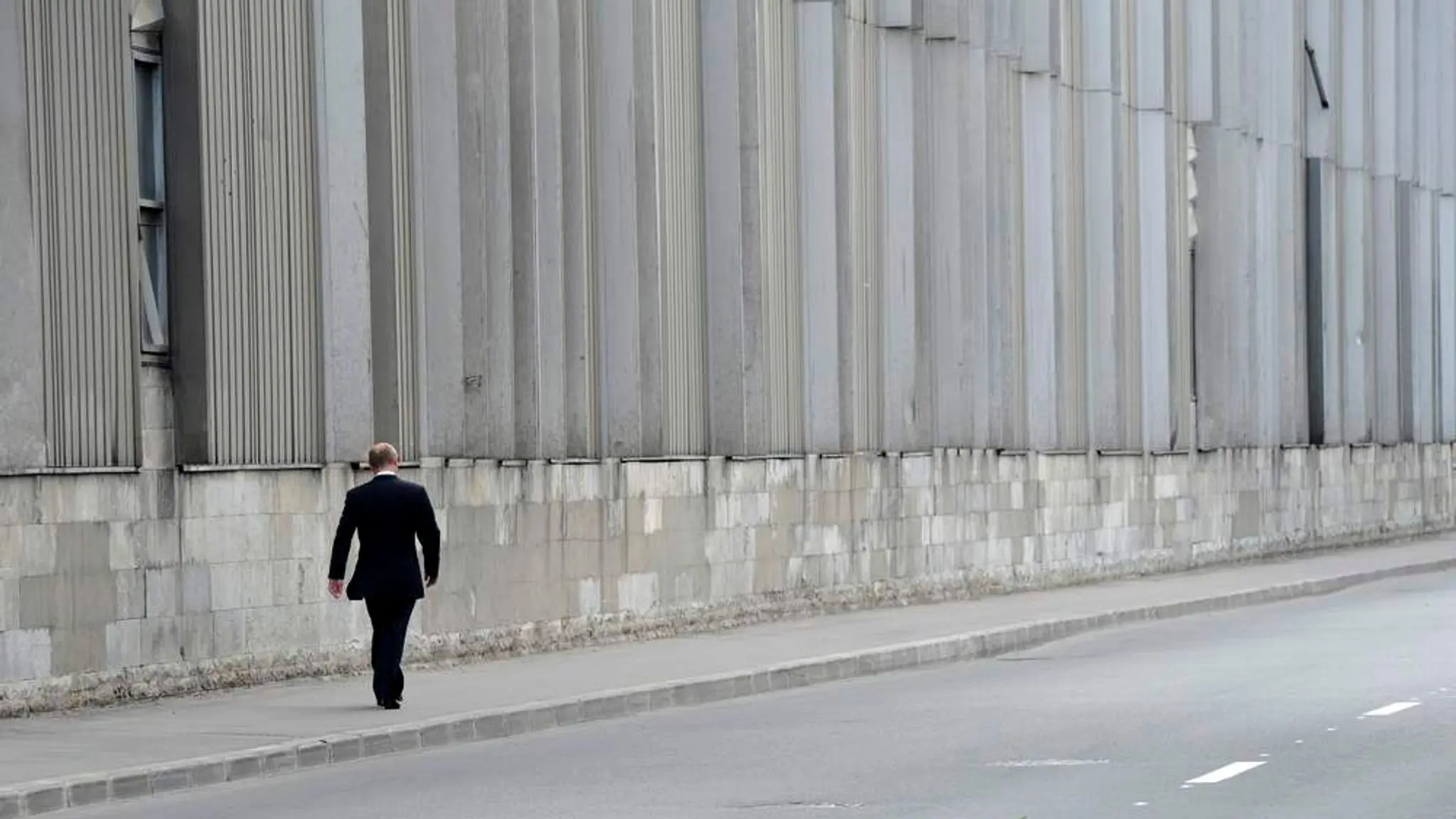 Vladimir Putin walking alone after his judo coach Anatoly Rakhlin's funeral in St. Petersburg, 2013